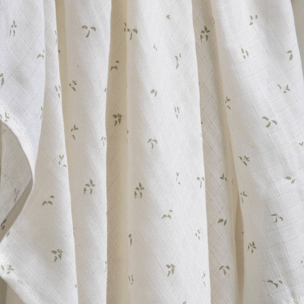 Close-up of white fabric with subtle pattern nettle scatter