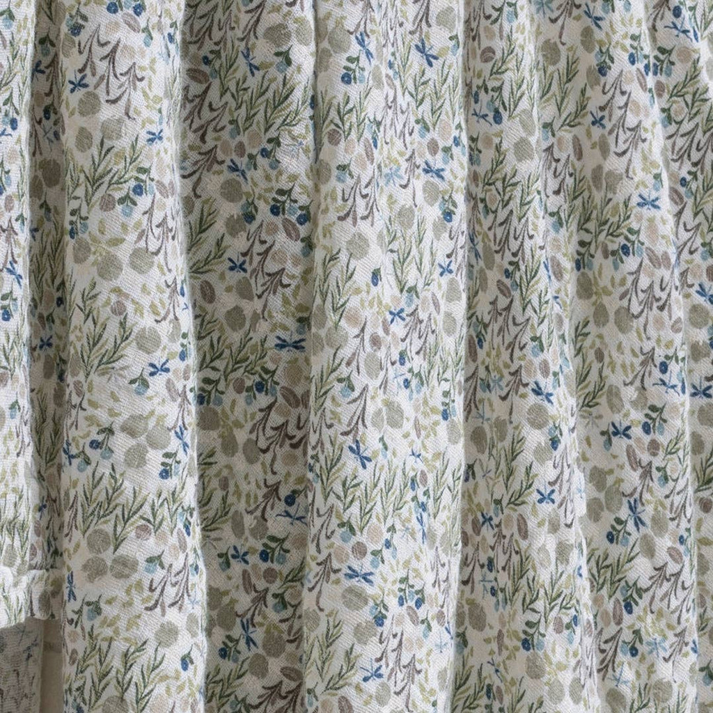 Floral patterned curtain with green, blue, and brown colors.