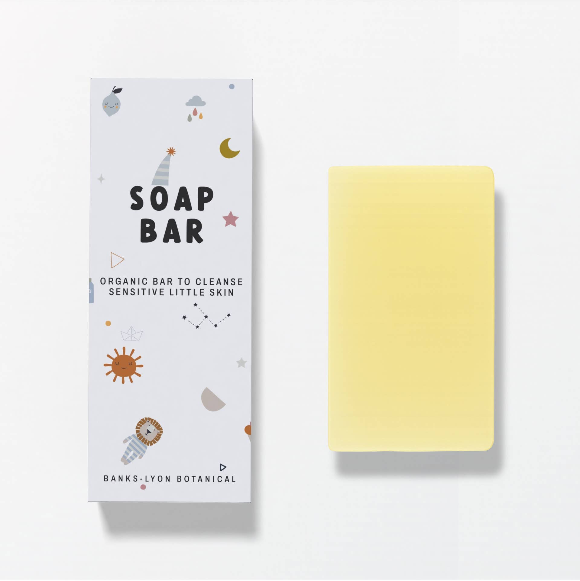 Yellow soap bar next to its packaging with 'Banks Lyon Botanical' branding on a light gray background