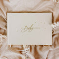 Beige journal with 'My Baby Journal' text on a textured beige surface