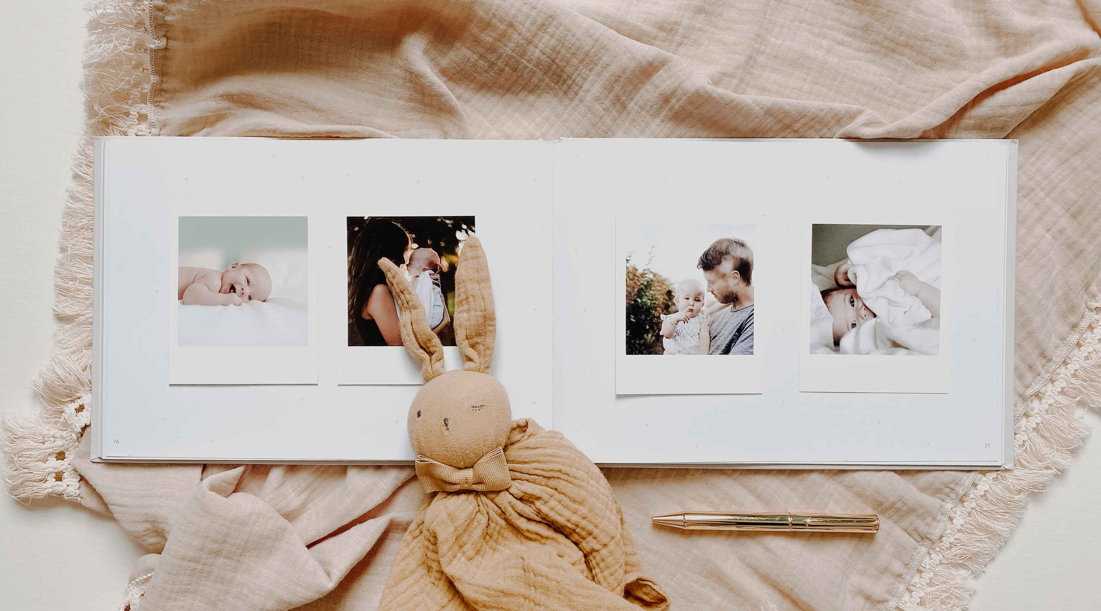 Album with family photos and a plush toy on a soft fabric background