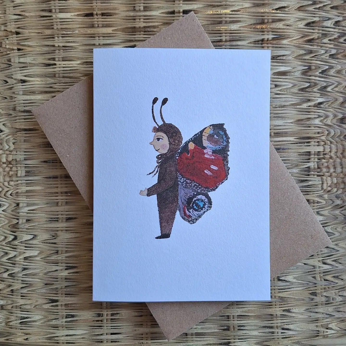 Greeting card with a butterfly costume design on a textured surface