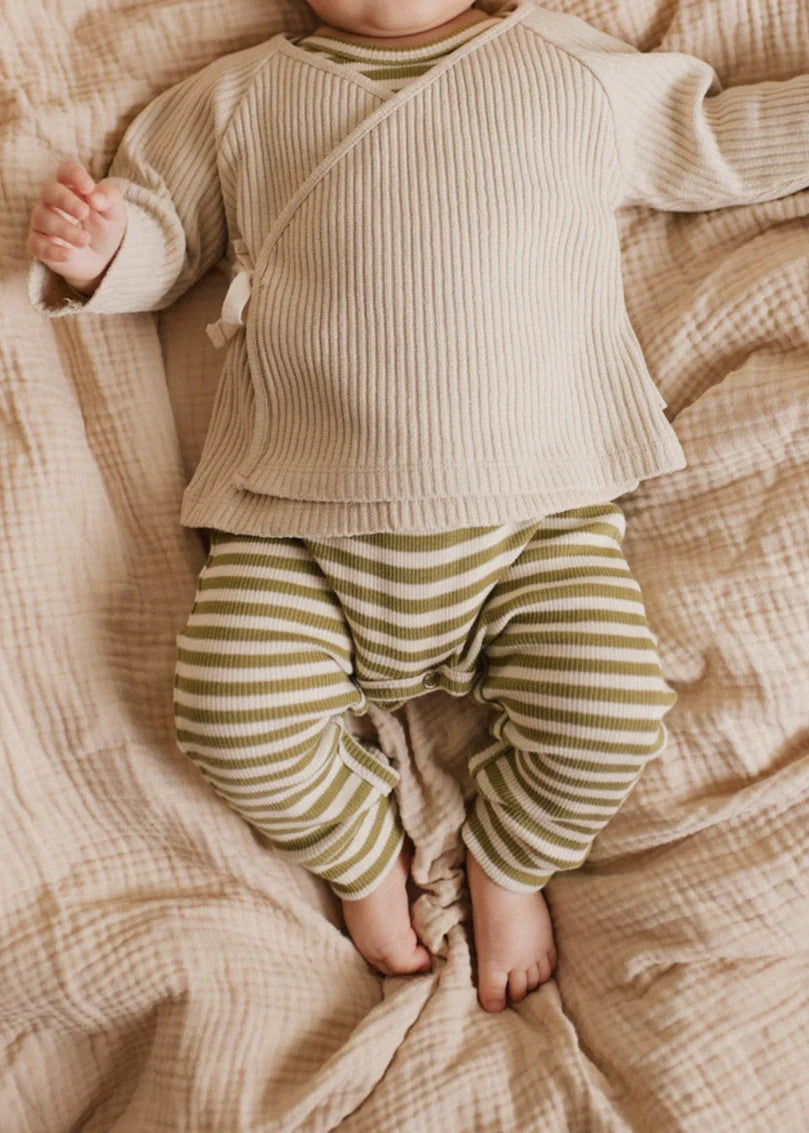 Baby wearing green sage and white stripe legging