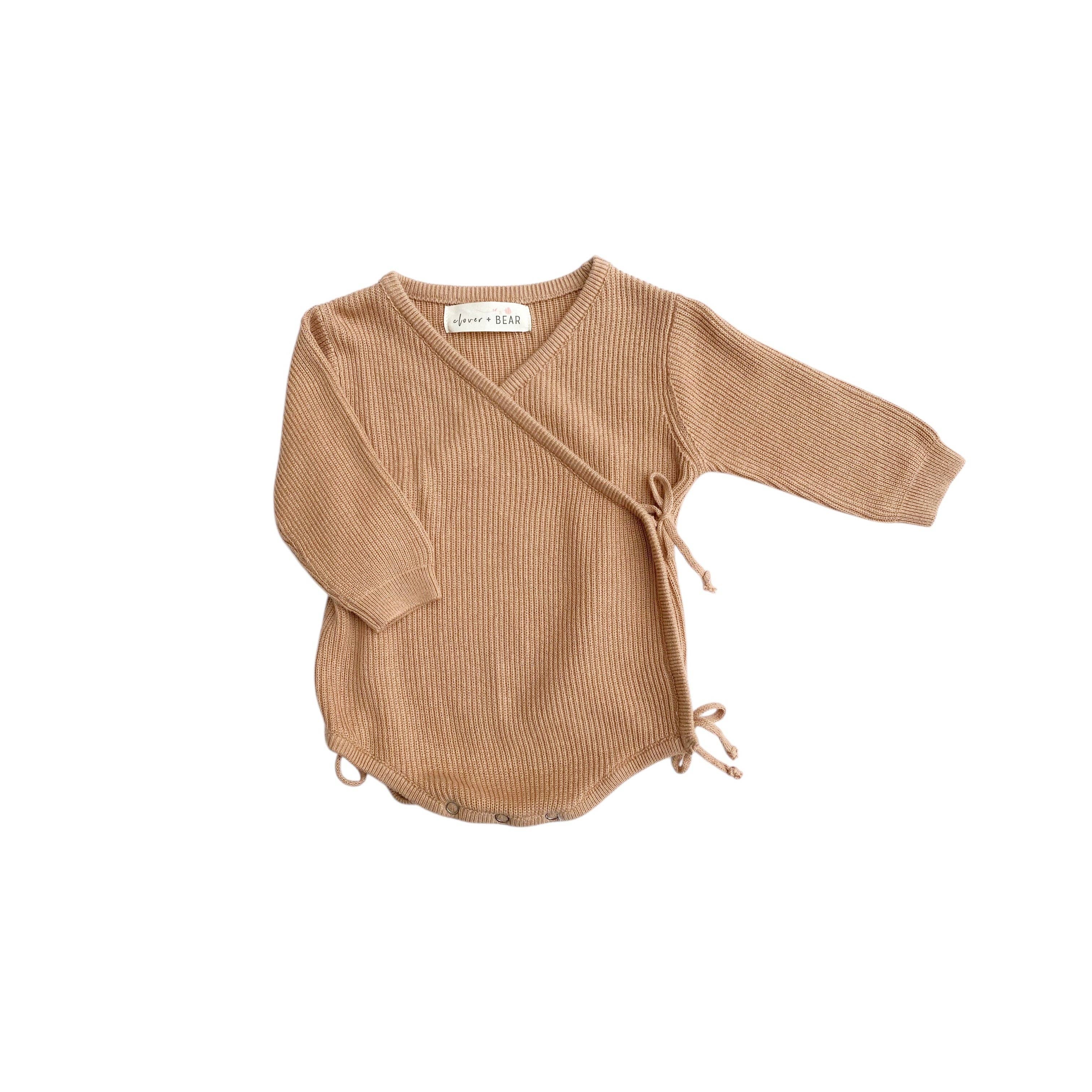 Brown ribbed baby romper with a tie front on a white background