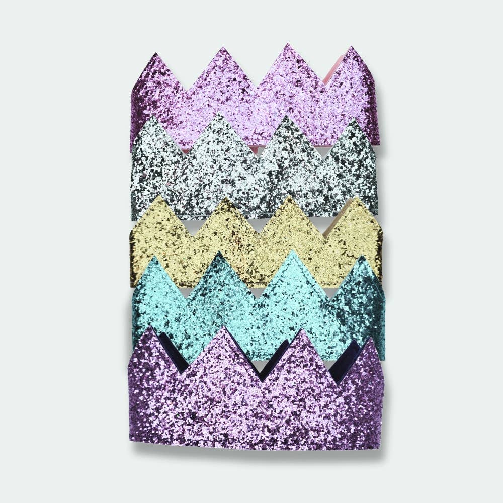 Colorful glittery crowns on a white background