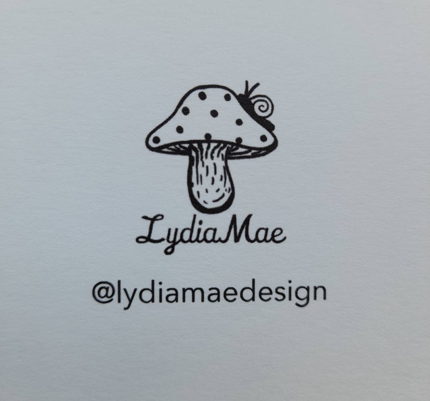 Mushroom logo with 'Lydia Mae' text on a light gray background