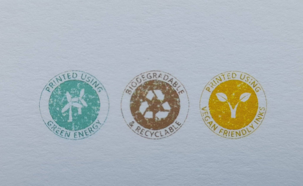 Three circular eco-friendly labels on a light gray background