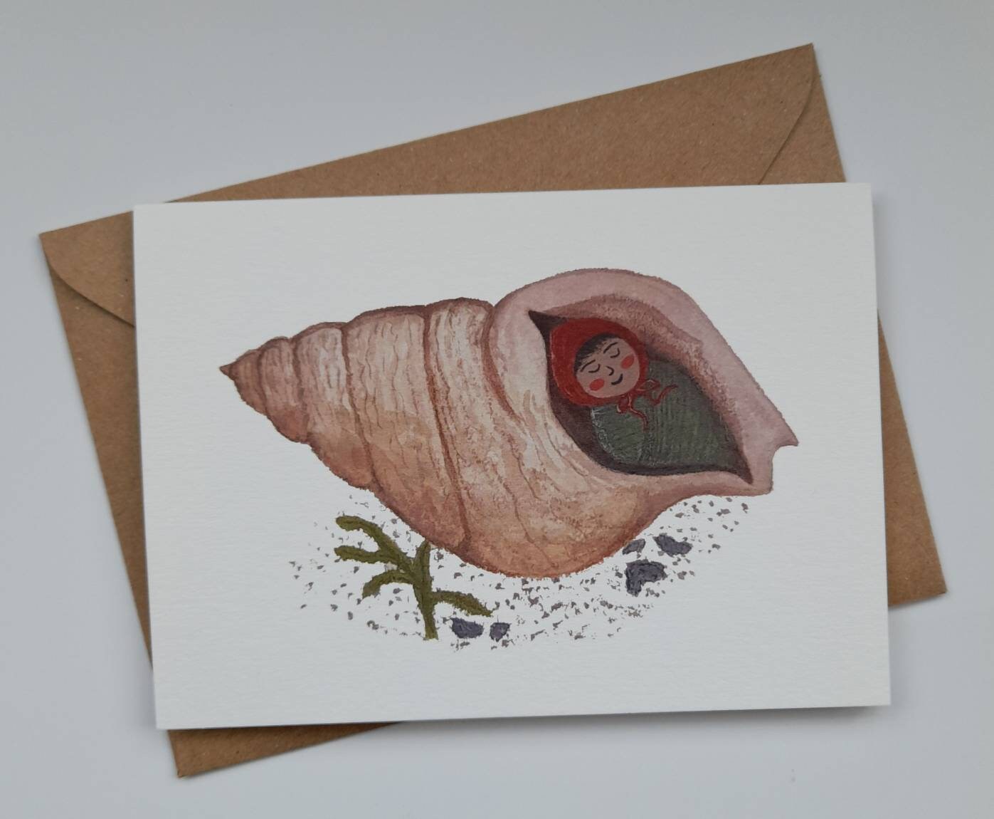 Card with a shell and mermaid illustration on a white background